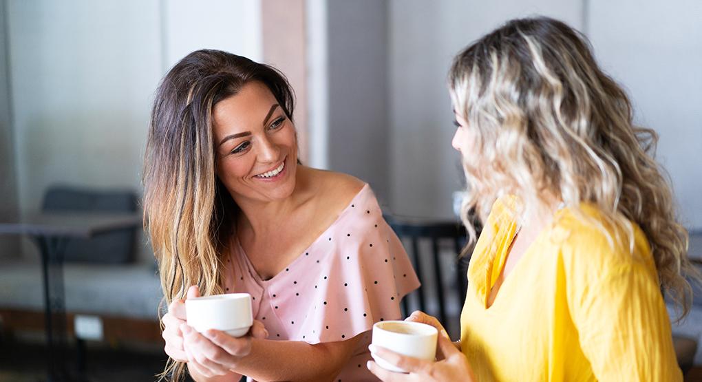 Two women drinking coffee