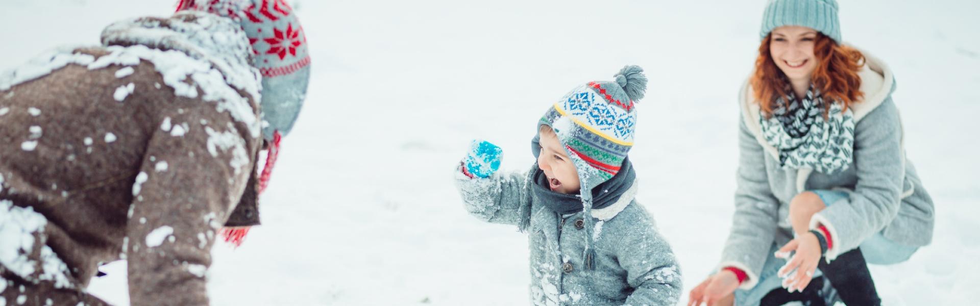 family playing in snow