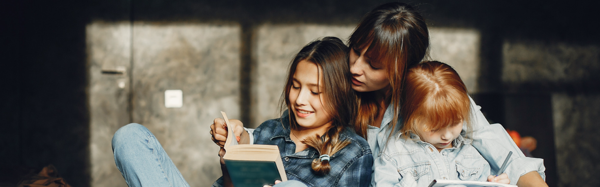 mother reading with daughters